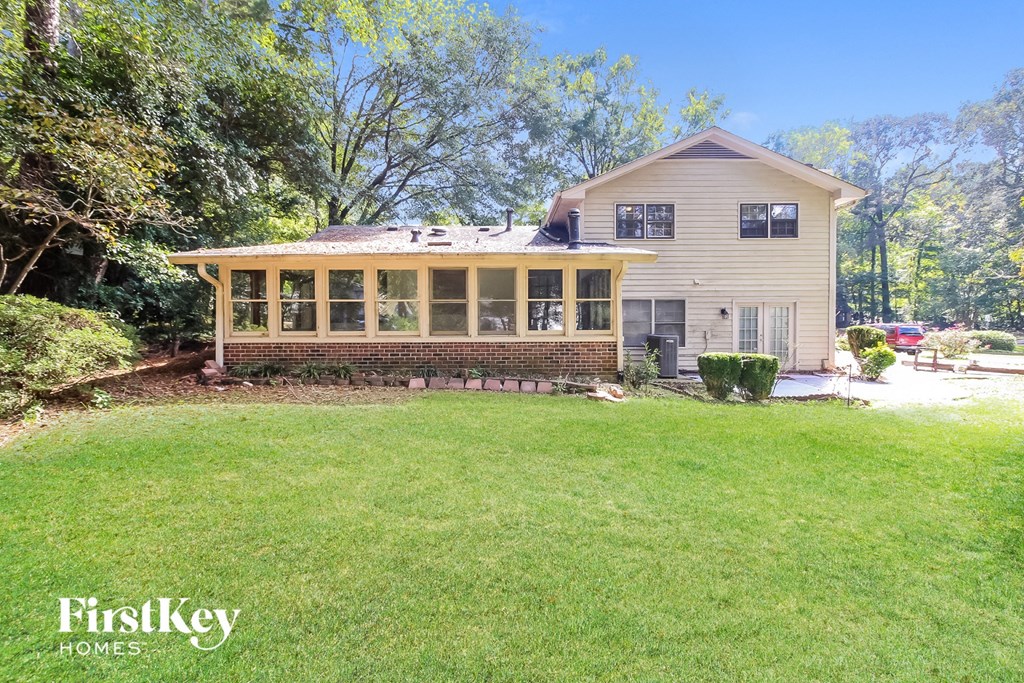 a house with a lawn and a screened in porch