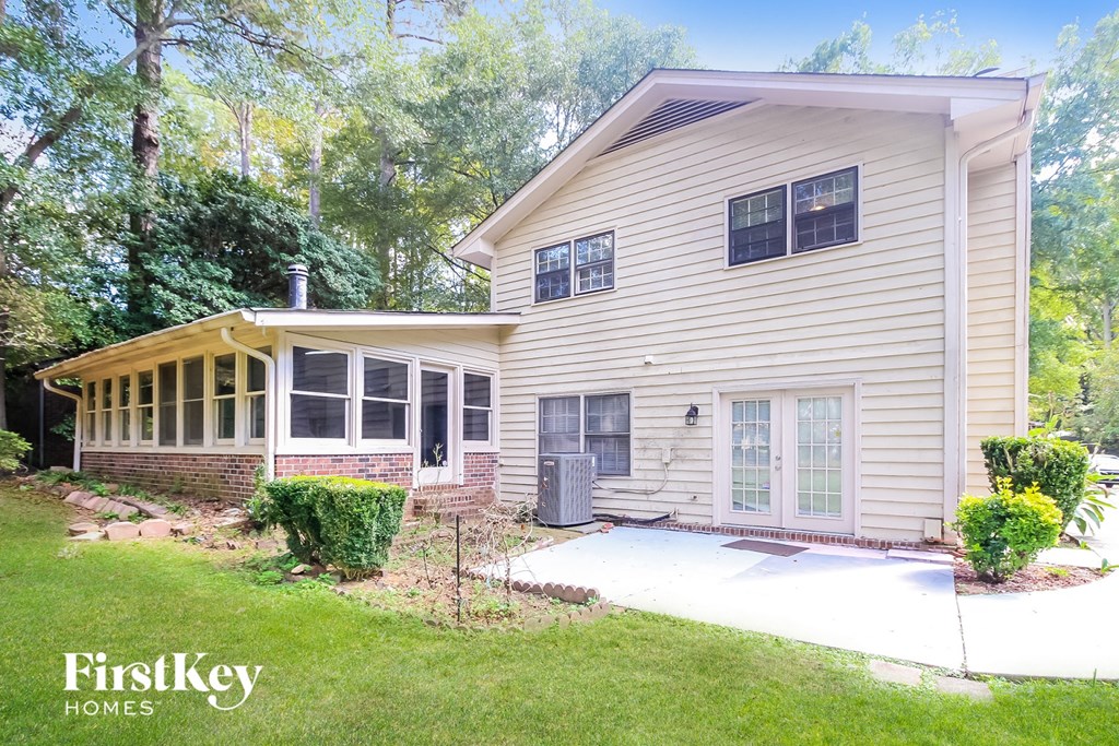 a white house with a porch and a backdoor