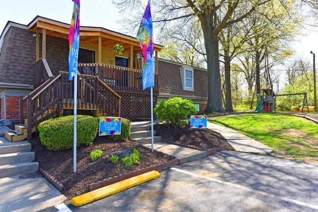 the front of a house with flags in front of it