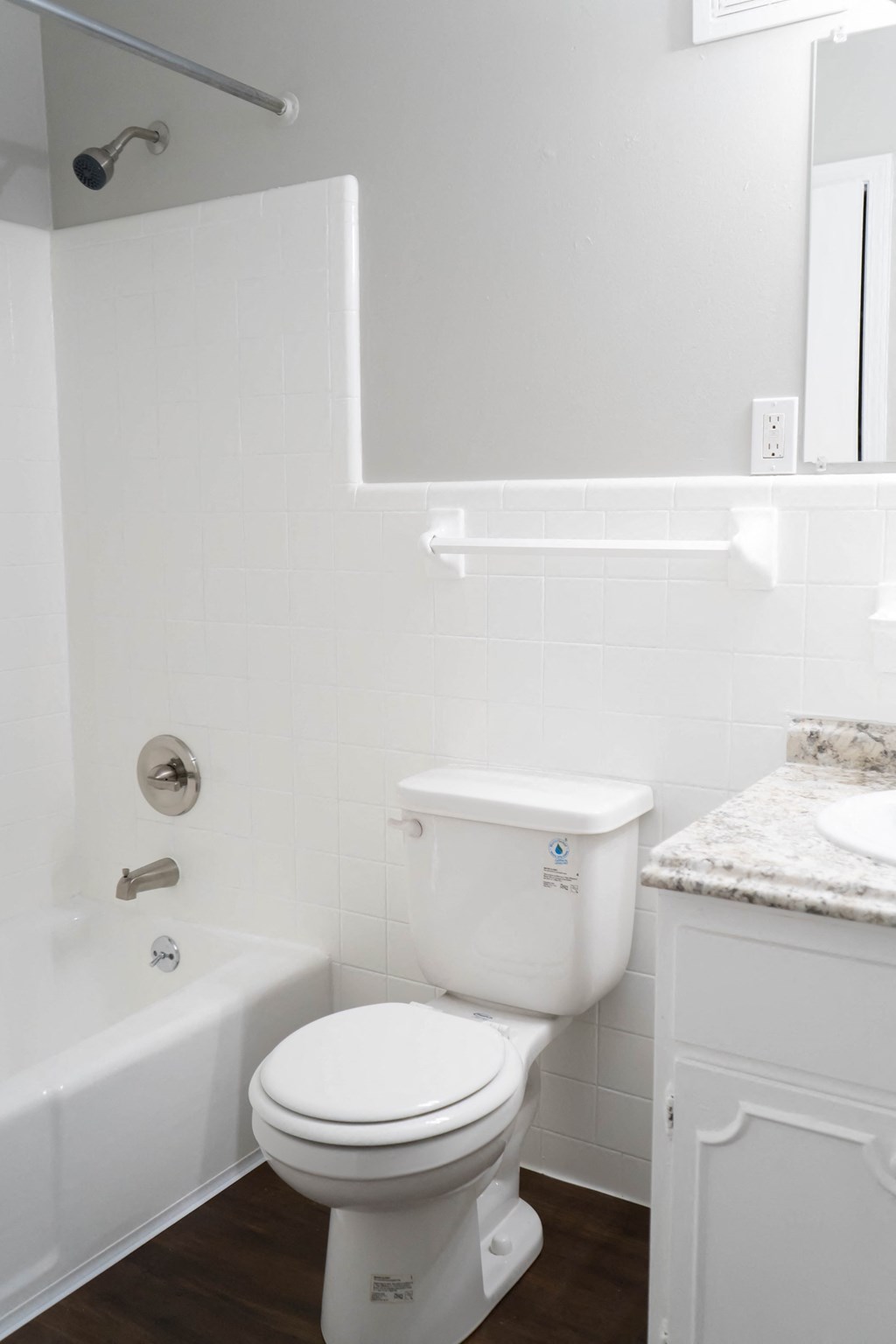 a white bathroom with a toilet and a tub