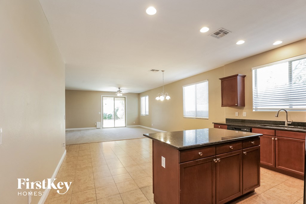 an open kitchen and living room with an island in the middle
