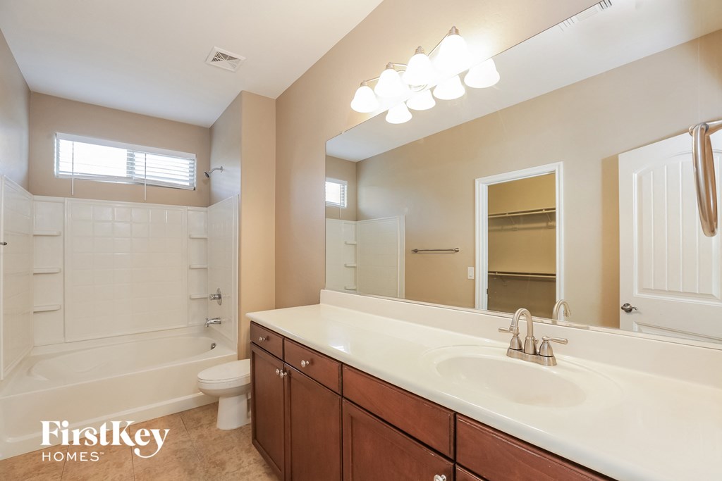 a bathroom with a sink and a shower and a toilet