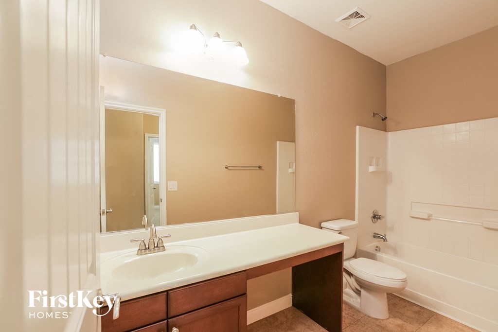 a bathroom with a sink and a toilet and a mirror