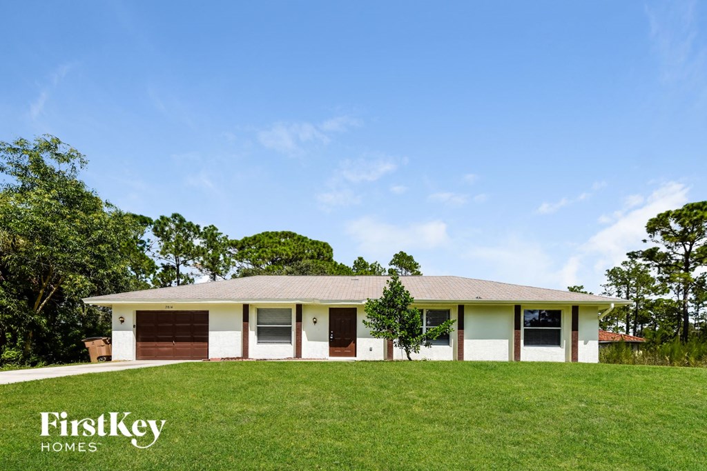 A house with a brown garage door is for sale.