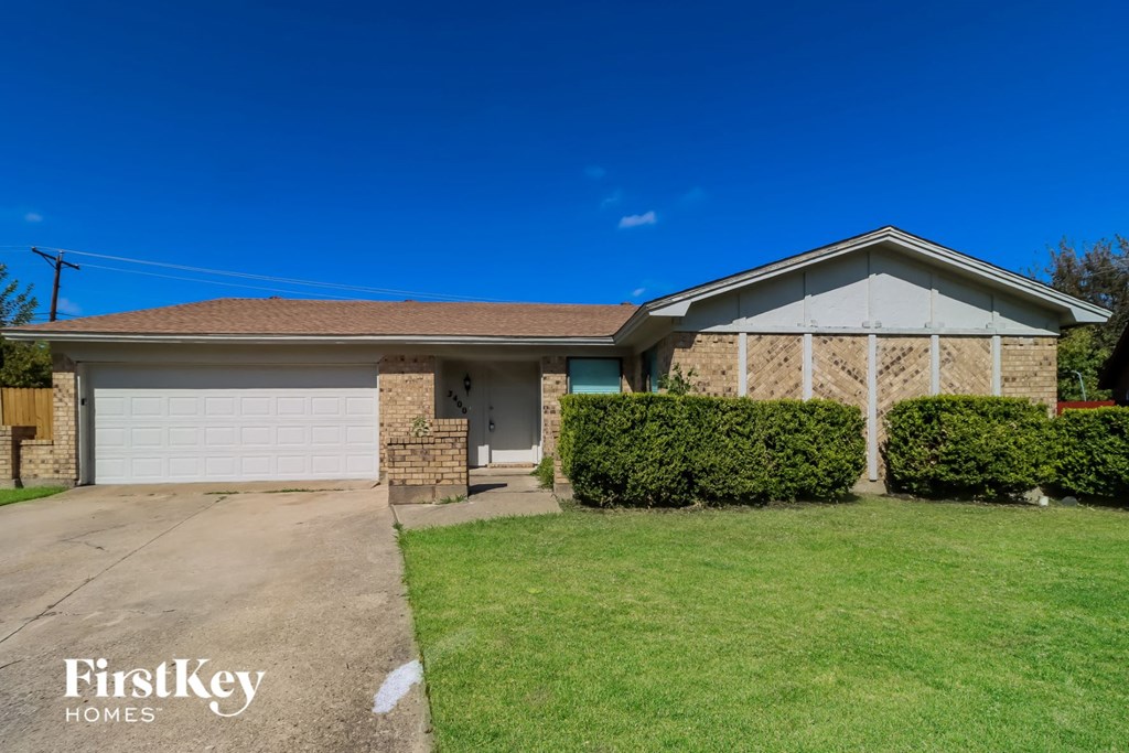 A house with a garage and a driveway is for sale.