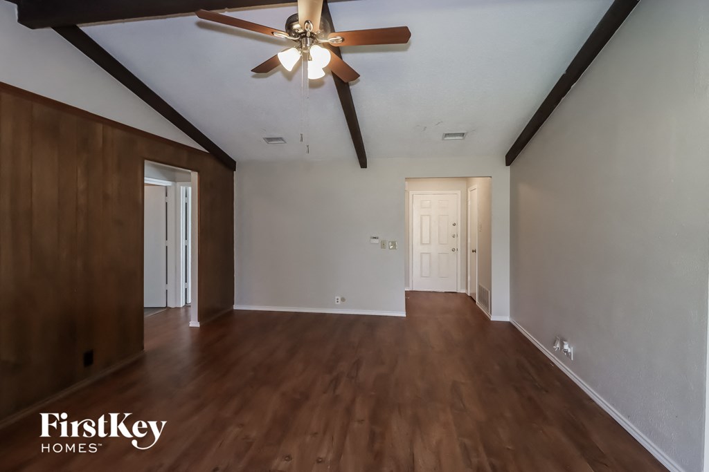 A room with wooden floors and a ceiling fan.