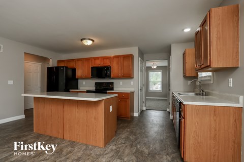 a kitchen with wooden cabinets and a white counter top