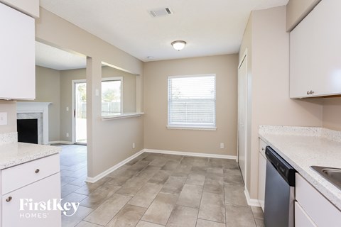 A kitchen with a dishwasher and a window.