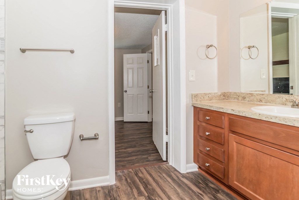 a bathroom with a toilet and a sink and a mirror