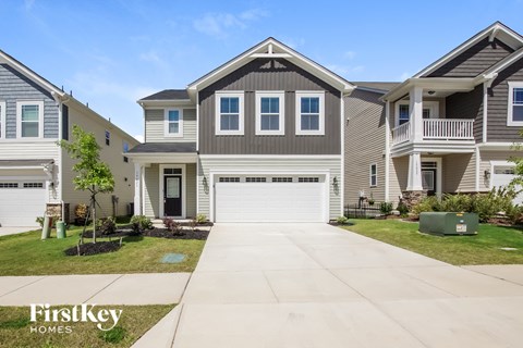a home with a white garage door in front of it
