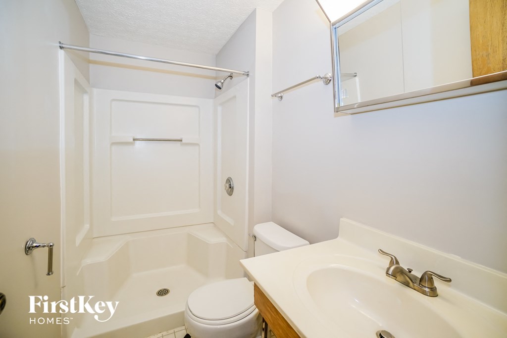 a small bathroom with a sink toilet and shower