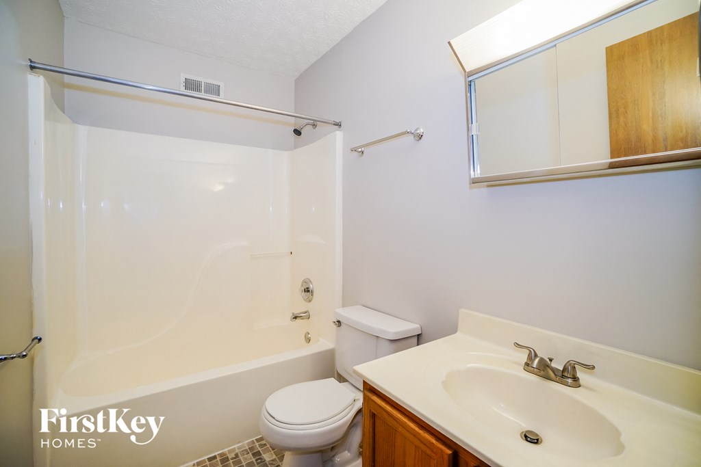 a bathroom with a shower toilet and sink