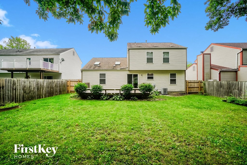 the backyard of a house with a yard and a fence