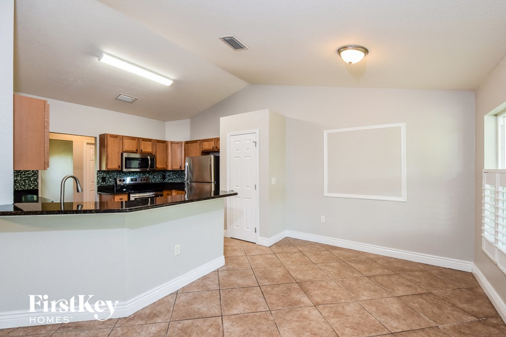 A kitchen with a counter top and a refrigerator.