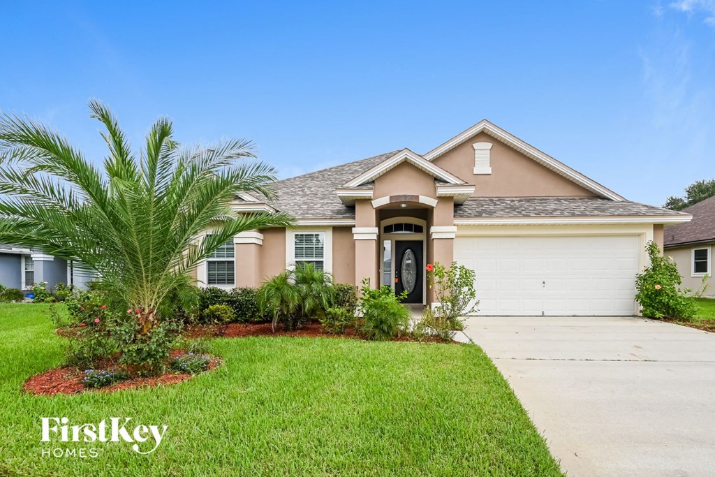 A house with a palm tree in front of it.