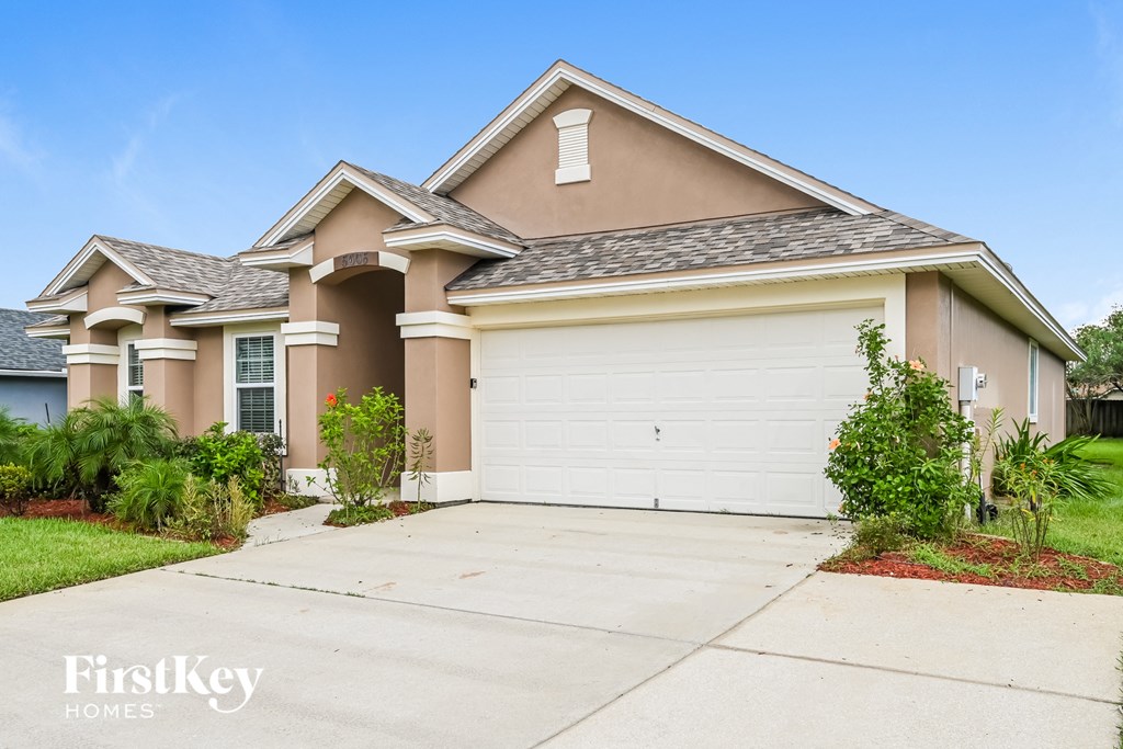 A house with a garage door and a driveway.
