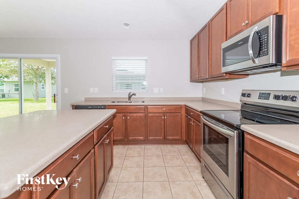 A kitchen with brown cabinets and a white countertop.