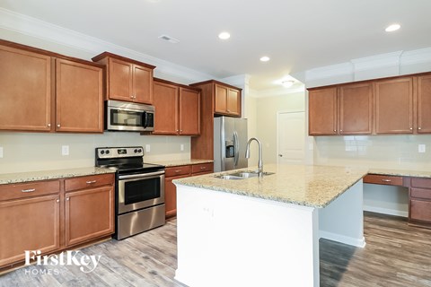 a kitchen with wooden cabinets and a marble counter top