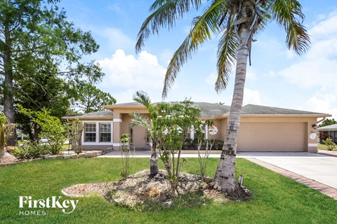 a house with palm trees in front of it