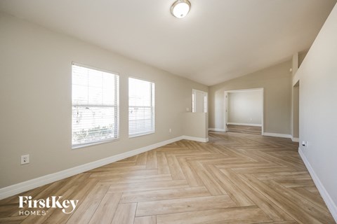 a spacious living room and dining room with hardwood flooring