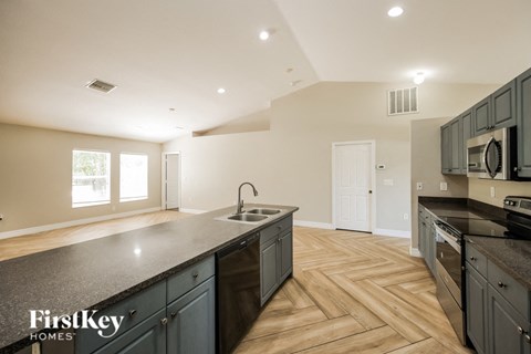 a kitchen with an island and a stove and a sink