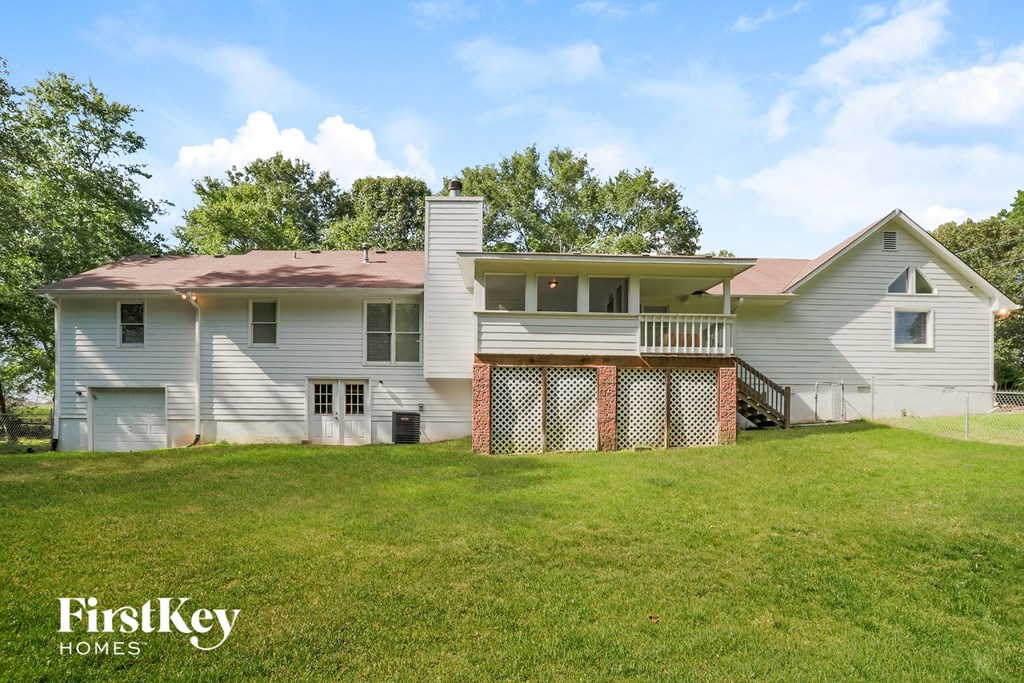 a white house with a yard and a fence