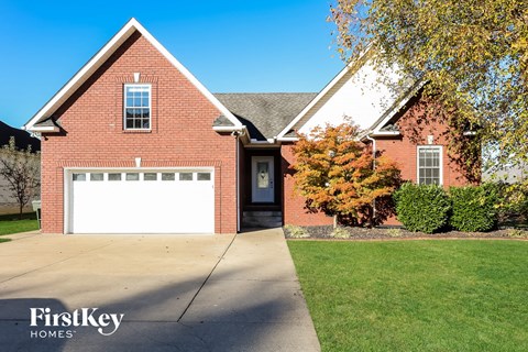a red brick house with a white garage door