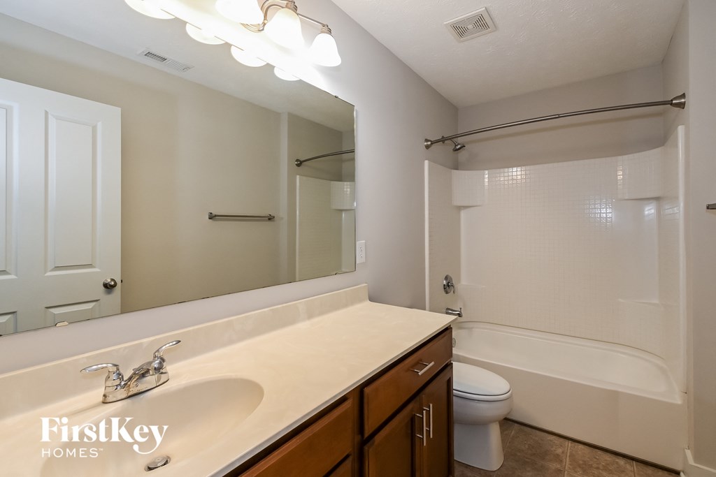a bathroom with a sink and a toilet and a mirror
