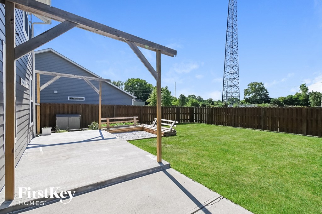 a patio with a bench in front of a building