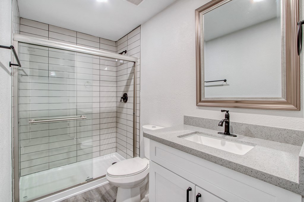 the ensuite bathroom has a large shower and a sink