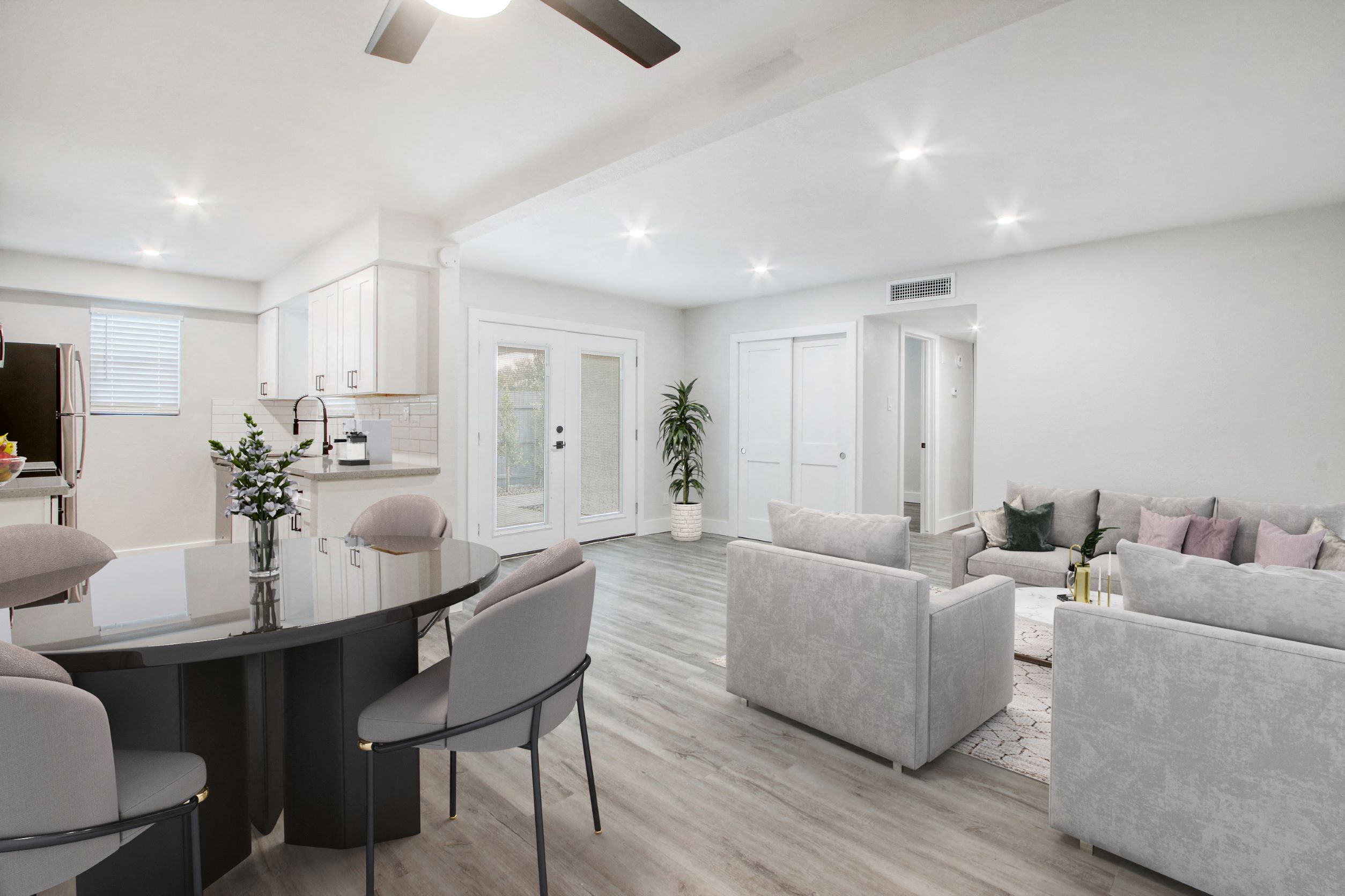 a living room and dining room with couches and a table