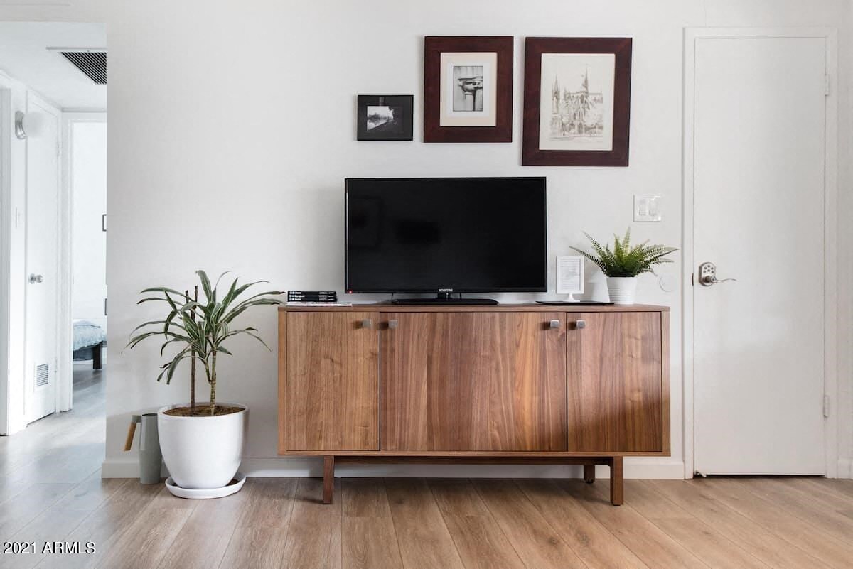 a living room with a television on top of a wooden cabinet