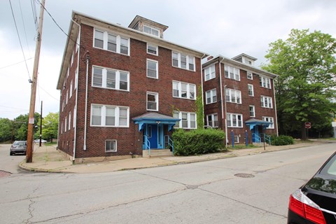 A red brick building with blue doors and windows.