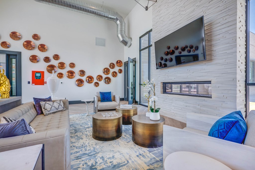 a living room with couches and tables and a fireplace