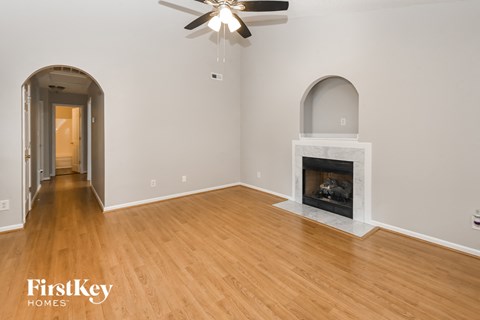 a living room with a fireplace and a wooden floor