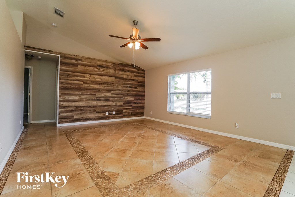 an empty living room with a reclaimed wood accent wall
