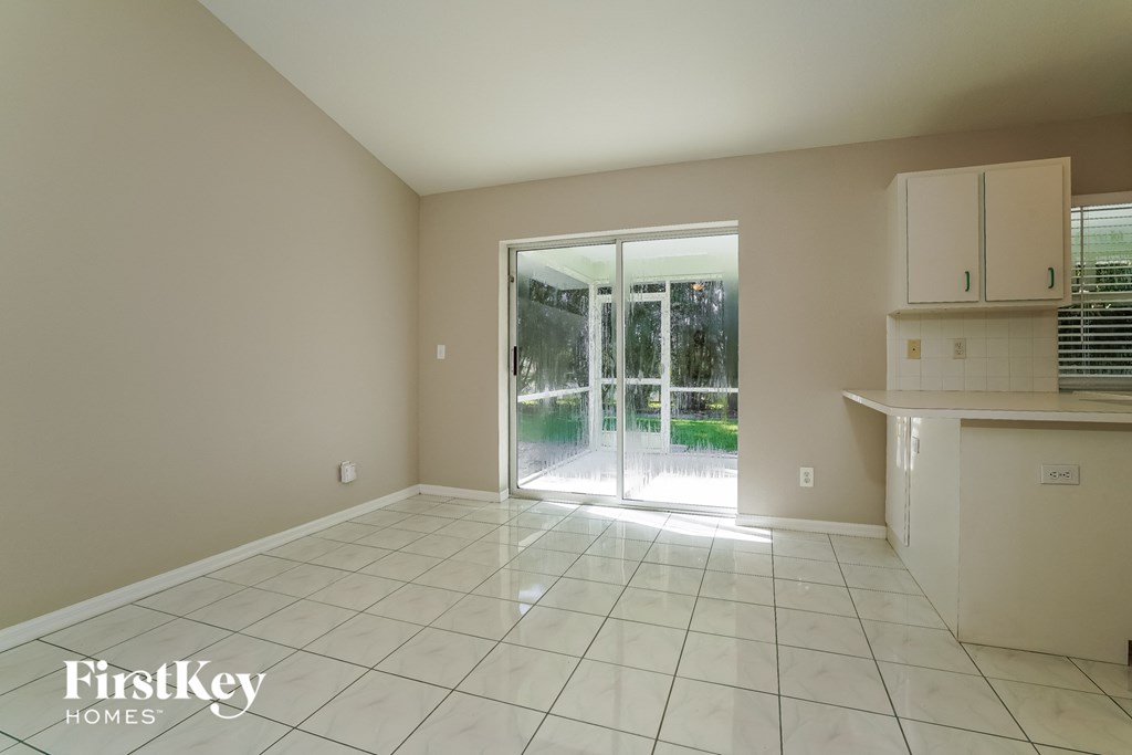 an empty living room with a sliding glass door to a patio