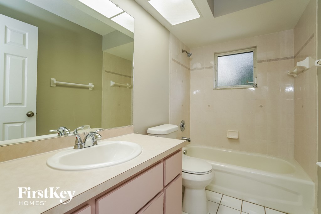 a bathroom with a sink and a toilet and a tub