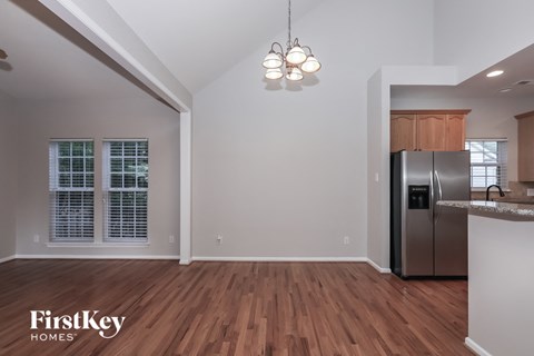 the kitchen is open to the dining room and living room