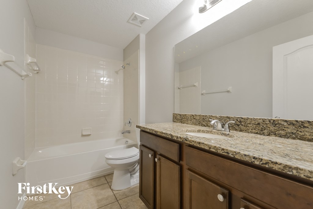 a bathroom with a sink and a toilet and a shower
