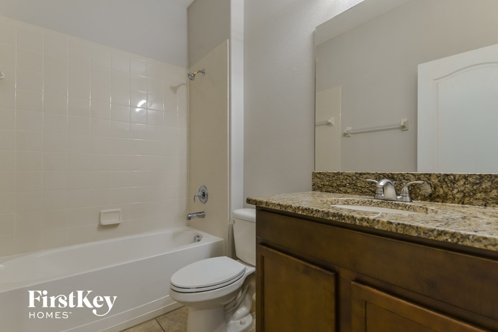 a bathroom with a sink and a toilet and a tub