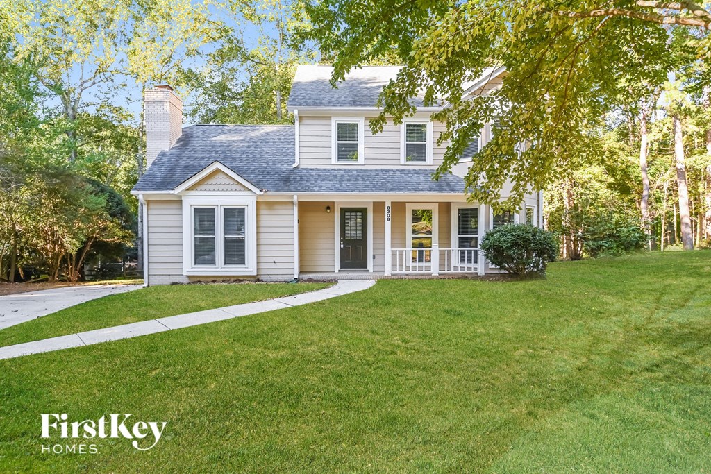 a white house with a yard and a sidewalk