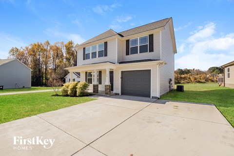 a white house with a garage and a driveway