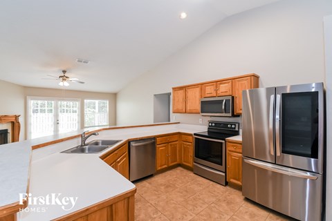 A kitchen with wooden cabinets and stainless steel appliances.