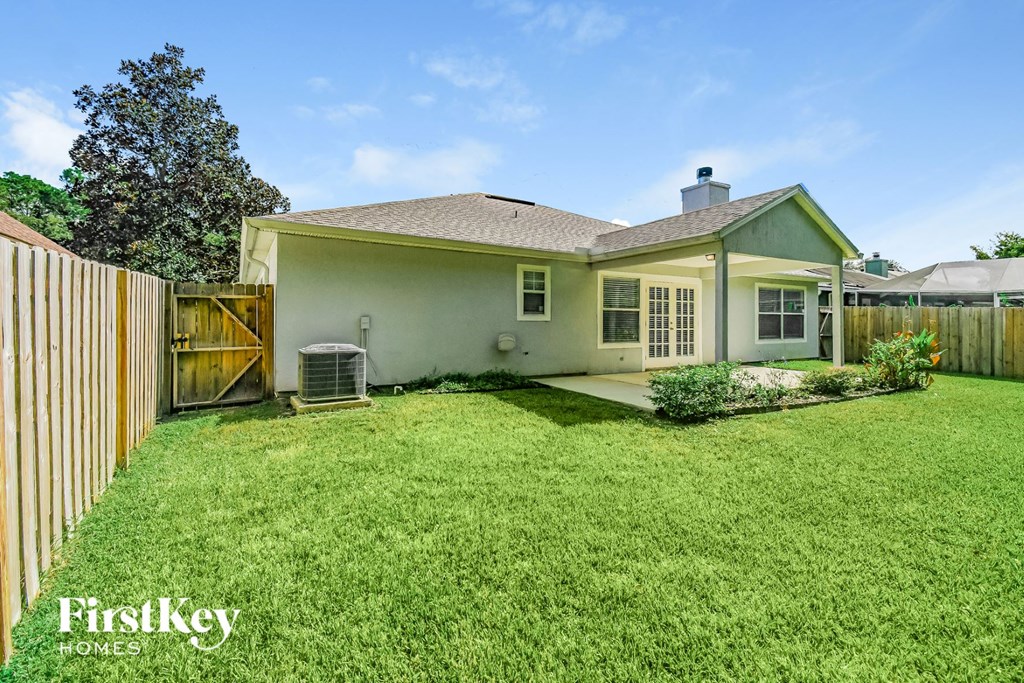 A house with a green lawn and a wooden fence.