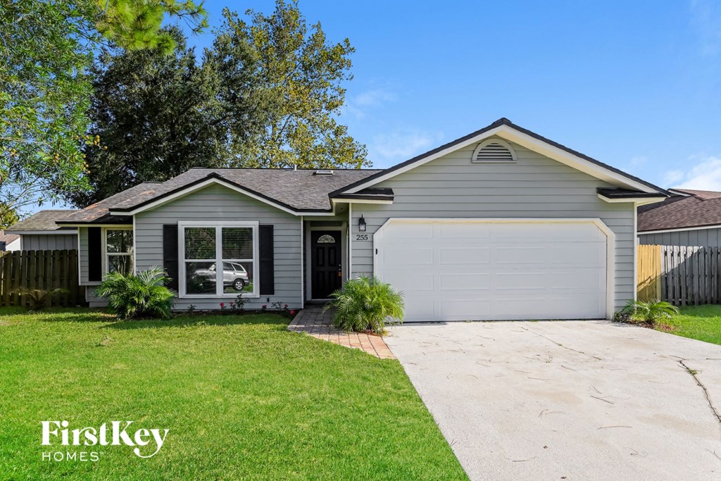 a gray house with a white garage door