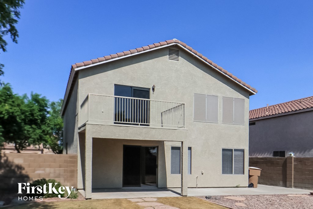 a white house with a balcony and a door