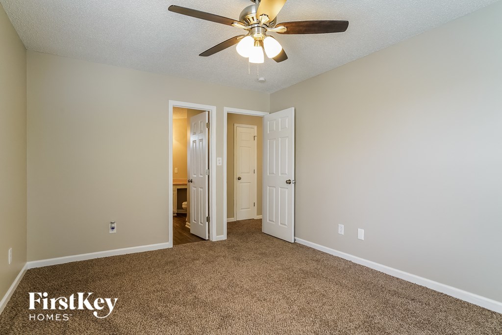 the master bedroom is spacious and has a ceiling fan