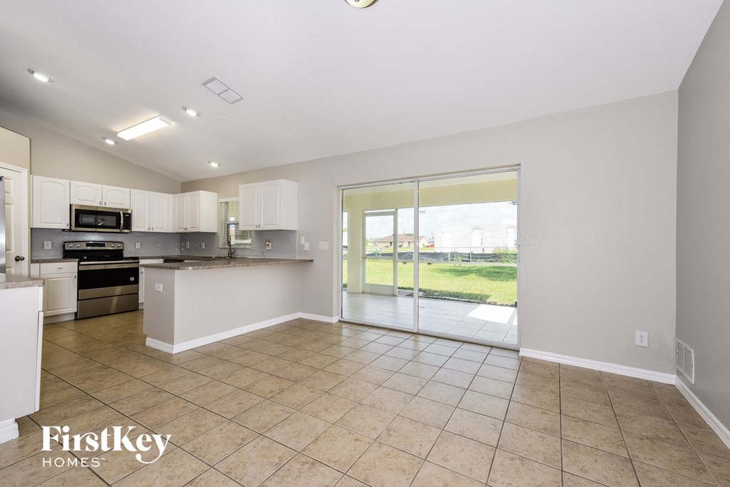 the living room and kitchen with sliding glass doors to the patio