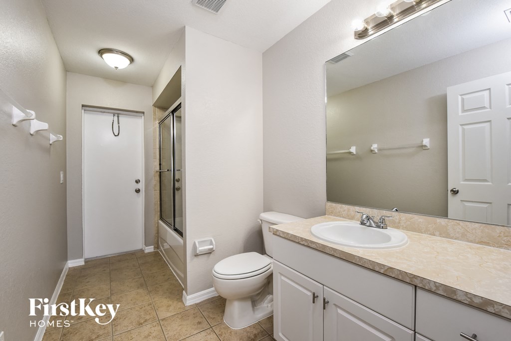 a bathroom with a sink toilet and a shower